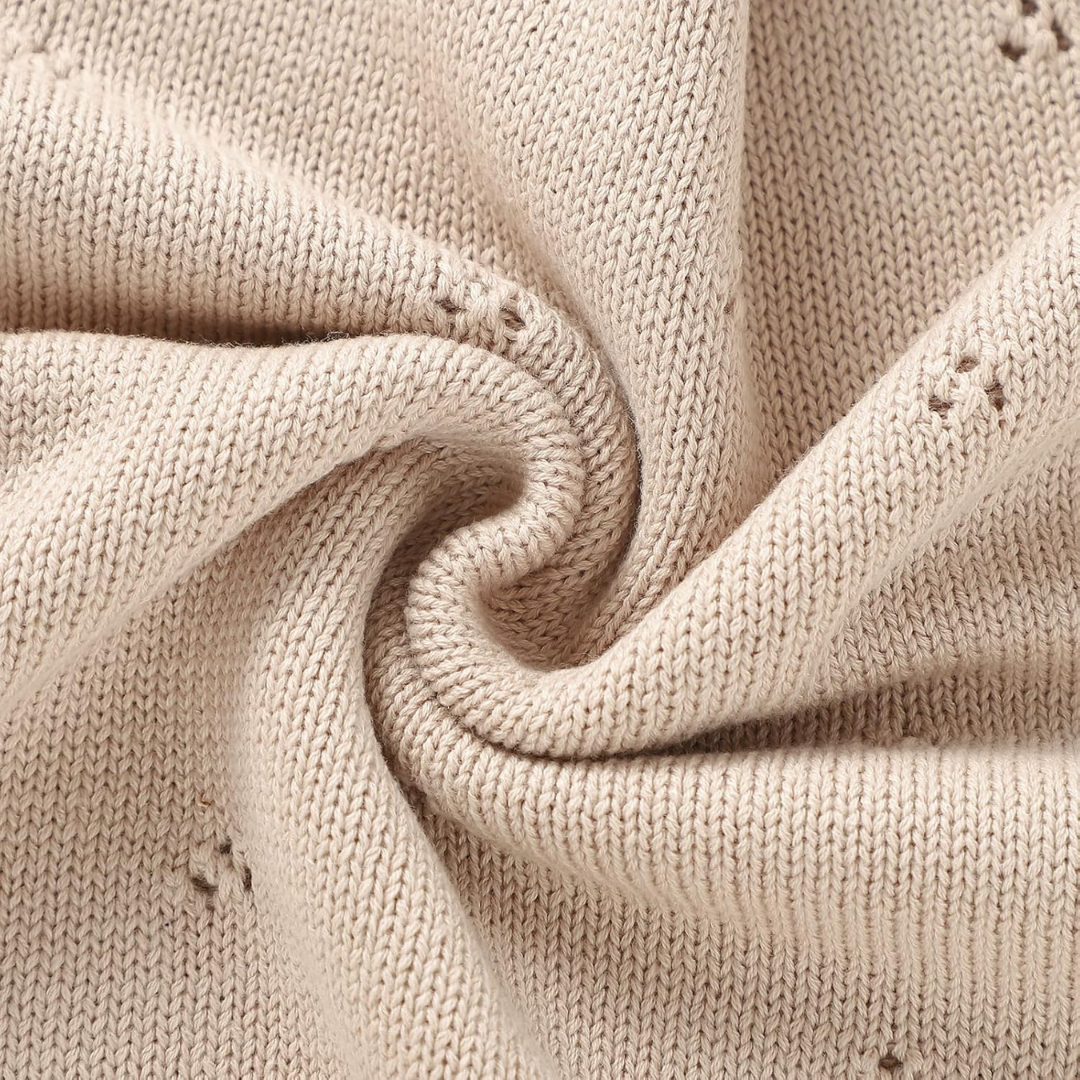 Close-up of beige knitted fabric with visible texture